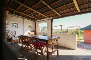 a dining room with a wooden table and chairs at CÉU DE AGARTHA Retiros e Vivências in Alto Paraíso de Goiás