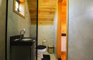 a small bathroom with a sink and a toilet at CÉU DE AGARTHA Retiros e Vivências in Alto Paraíso de Goiás +62 photos