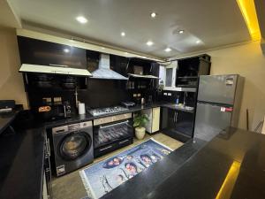 a kitchen with a stove and a washer and dryer at The Perfect in Alexandria +42 photos