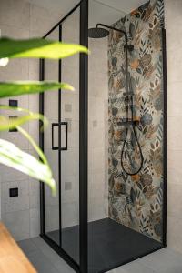 a shower stall in a room with a wall at Chata Špička in Smržovka +29 photos