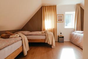 a bedroom with two beds and a window at Chata Špička in Smržovka