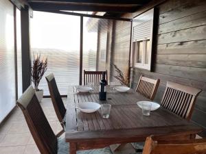 a wooden table with bowls on it on a porch at Casa rural Vega alta in Madridejos