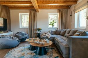 a living room with a couch and a table at Chata Špička in Smržovka