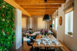 a dining room with a table and chairs and a green wall at Chata Špička in Smržovka