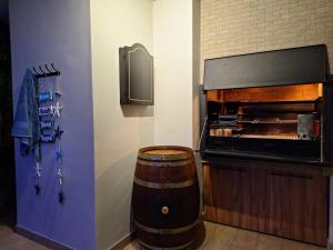 a room with a wine barrel next to aburning at Calypso Sunset Accommodation in Langebaan