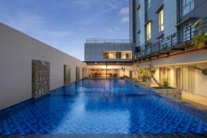 a swimming pool in the middle of a building at Amandaru Hotel Pekalongan in Pekalongan