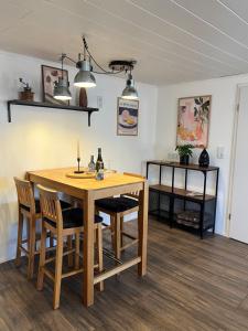 a dining room with a wooden table and chairs at Ferienhaus Luunsche Landpause in Lunow