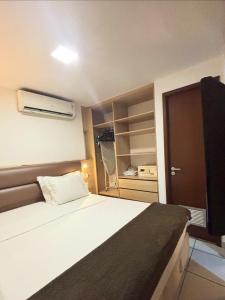 a small bedroom with a bed and a closet at Beach Class Fortaleza by AM in Fortaleza +51 photos