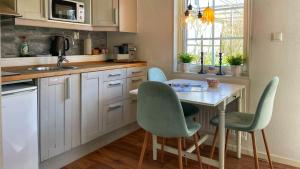 a kitchen with a table and four chairs at Stuga smögen in Smögen
