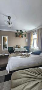 a bedroom with a large bed and a table at Árból Guesthouse in Húsavík