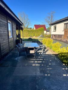 a table and chairs on a sidewalk next to a building at Ferienhaus Luunsche Landpause in Lunow