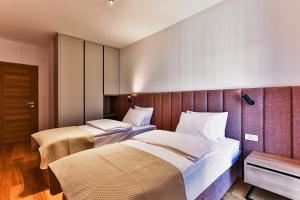 a hotel room with two beds in a room at Numa by Kraft in Podgorica
