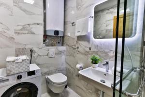 a white bathroom with a sink and a toilet at Numa by Kraft in Podgorica +51 photos