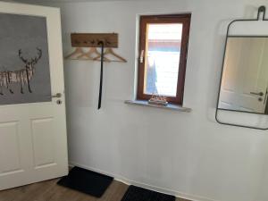 a room with a mirror and a window and a door at Fewo Kleine Gasse, super Zentral, Privat Parkplatz, in Ruhla