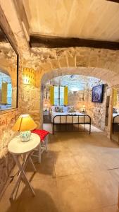 a room with two beds and a table with a lamp at L'Artiste Guest House in Xagħra