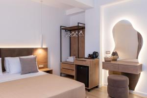 a bedroom with a bed and a desk with a chair at Villa White in Ksamil