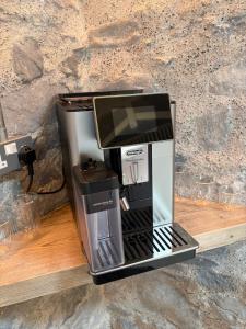 a coffeemaker sitting on a wooden counter top at Neds Barn in Galway +7 photos