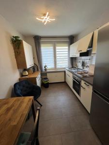 a kitchen with white cabinets and a table and a window at Über dem Dörpken in Wuppertal +4 photos