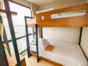 a bunk bed in a room with a window at Lovina 21-AA at One Residence in Batam Center +13 photos