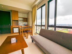a living room with a couch and a table at Lovina 21-AA at One Residence in Batam Center