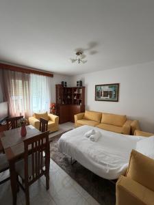 a living room with a large bed and a couch at Alex Guest Apartment in Gjirokastër