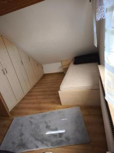 a small room with two beds and a rug at Ferienhaus König in Kurort Steinbach-Hallenberg