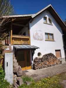 a large white house with a bunch of rocks in front of it at Ferienhaus König in Kurort Steinbach-Hallenberg