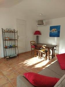 a living room with a table and a couch at villa des calanques in Conca