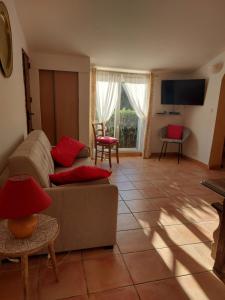 a living room with a couch and a tv at villa des calanques in Conca