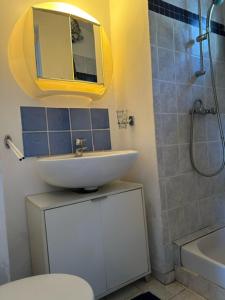a bathroom with a sink and a toilet and a shower at villa des calanques in Conca +8 photos