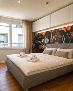 a bedroom with a large bed with towels on it at Bodensee Loft in Daisendorf
