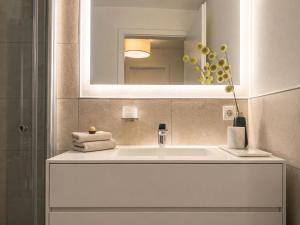 a bathroom with a white sink and a mirror at Bodensee Loft in Daisendorf +18 photos