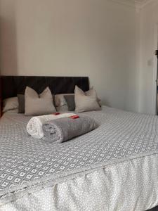 a bed with two towels on top of it at Budget Rooms Lincoln City Centre , Fast WiFi & Self Check in in Lincoln