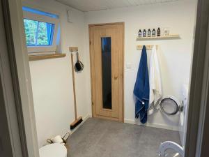 a bathroom with a toilet and a door at Villa Yasjö in Eringsboda +60 photos