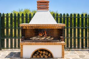 a brick oven with a bunch of food inside at Villa Valio in Dhrapanítika