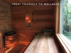 a small sauna with a bench in front of a window at Romantic Golden Spa Suite in Lambton Shores
