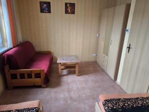 a living room with a couch and a table at Ferienhaus B1 Concordiasee in Friedrichsaue +5 photos