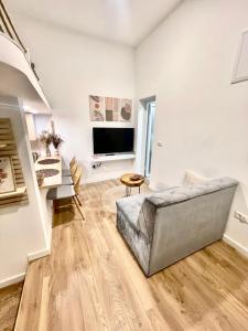 a living room with a couch and a television at Biosphere Lux Apartments in Sarajevo