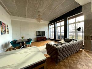 a living room with a couch and a table at Tamula Lake View Apartment in Võru