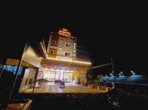 a building with a sign on top of it at night at Hotel Shree Raghunandan Palace in Ujjain