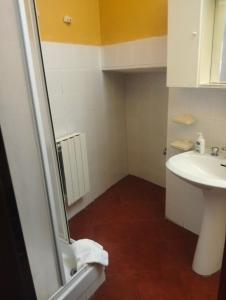 a bathroom with a sink and a toilet at Appartamento Oleandro in Montale +28 photos
