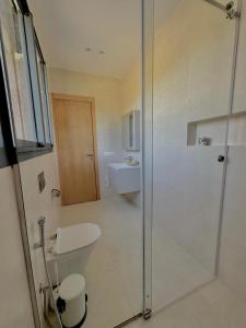 a bathroom with a shower and a toilet and a sink at Villa Dream el filali in Sraghna +3 photos