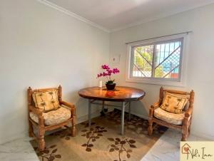 a dining room with a table and two chairs at Nol's Inn in Iloilo City