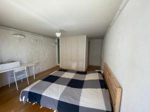 a bedroom with a bed and a desk in it at La cameretta in Mont-sur-Rolle