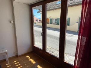 an open door with a view of a street at La cameretta in Mont-sur-Rolle