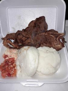 a styrofoam container with meat and other foods in it at The Seige Guesthouse in Pretoria