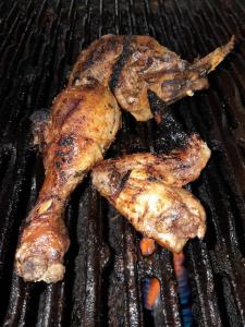 three pieces of meat cooking on a grill at The Seige Guesthouse in Pretoria