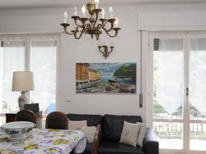 a living room with a chandelier and a dining room table at Villa Maremonti - con 3 piscine in Sestri Levante