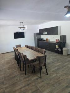 a conference room with a wooden table and chairs at Casa Tudor - Râul Mare Retezat in Clopotiva +29 photos