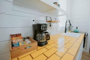 a kitchen counter with a coffee maker on it at The Frida Tiny House-Hot Tub-Pet Friendly-No Pet Fee! in Albuquerque